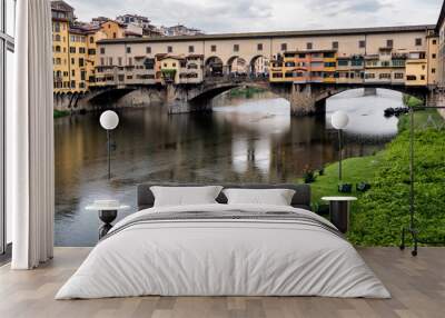 Ponte Vecchio, famous old bridge in Florence on the Arno river, Firenze, Tuscany, Italy - on a dramatic cloudy day Wall mural