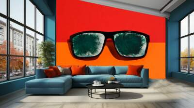 Summer concept of rest and fun. Sunglasses decorated with green paper. Insulated in two colors. Red and orange. Wall mural