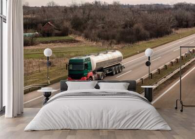 Tank truck on a rural country highway or motorway with light traffic Wall mural