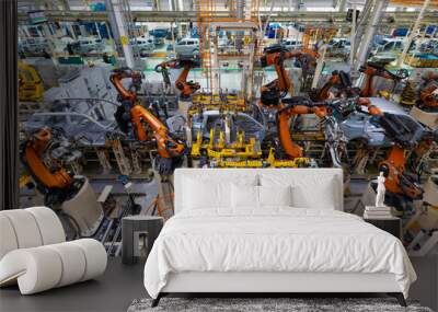 assembly line in a car factory, welding with robots, automated work Wall mural