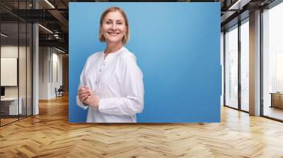 beautiful cute blond middle aged woman in white blouse in premenopausal age Wall mural