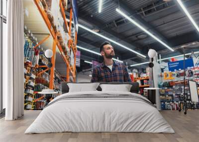 buy a man walking with a basket in a hardware store Wall mural