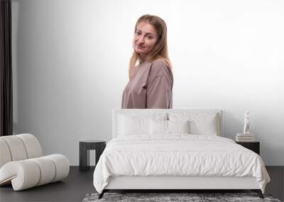 Close-up of a Caucasian blond woman wearing a T-shirt on a background with copy space Wall mural