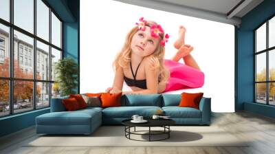 Cute pretty little girl in black bikini, pink skirt and pink wreath, lies Wall mural