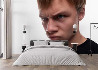 Offended young man with blond hair wearing a black T-shirt Wall mural