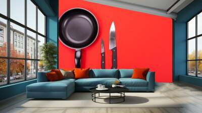 Top view of cooking utensils composition in kitchen isolated on red background Wall mural