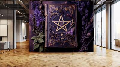 vintage grimoire with pentacle emblazoned cover surrounded by purple flowers and herbs Wall mural