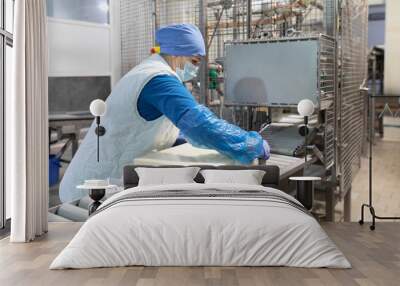 Worker packs butter at the dairy plant Wall mural