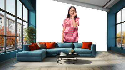 young worried brunette woman in a striped t-shirt on a white background with copy space Wall mural