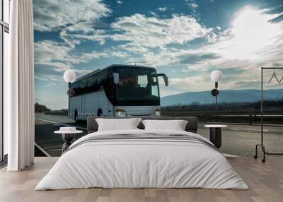 white modern comfortable tourist bus driving through highway at bright sunny sunset. travel and coac Wall mural