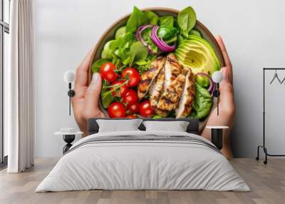 Woman's hands holding a bowl with salad with tomatoes, chicken, avocado, green leaves, top view of only hands with space for text or inscriptions, healthy eating theme.isolated.generative ai
 Wall mural