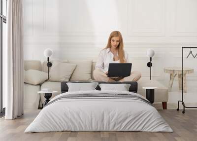 Woman working at home at the computer. Woman who is away from home. Wall mural