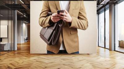 man in casual style. a man in a jacket with a phone in his hand. business meeting Wall mural