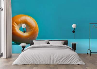 crispy bagel with seeds on blue background for breakfast and a copy space Wall mural