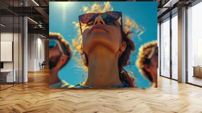 group of people looking at the blue sky with glasses on  Wall mural