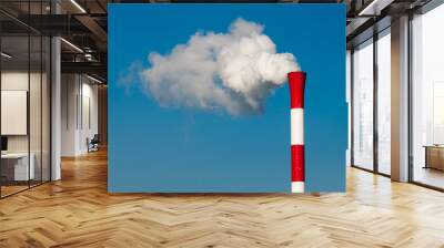 Red and white factory chimney with blue sky background Wall mural