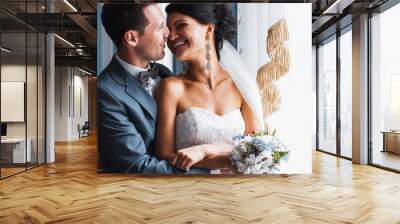 Wedding couple standing embracing in the palace Wall mural