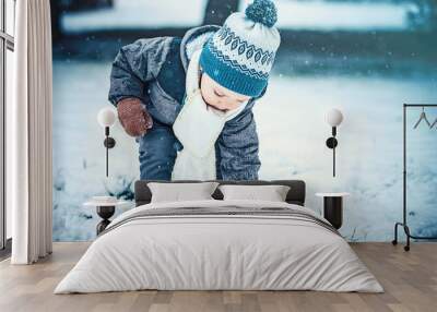 Adorable little boy having fun on winter day Wall mural