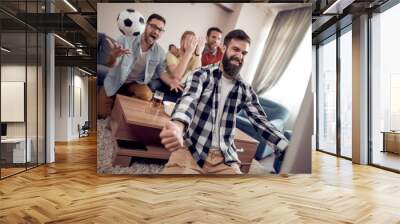 Cheerful group of friends watching football game on tv Wall mural