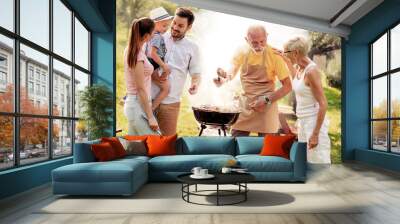 Family having a barbecue in the garden Wall mural