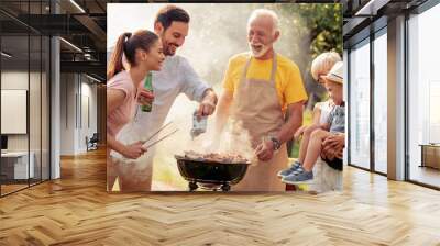 Family having a barbecue party in their garden in summer Wall mural