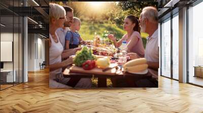 Family having a lunch in their garden in summer Wall mural