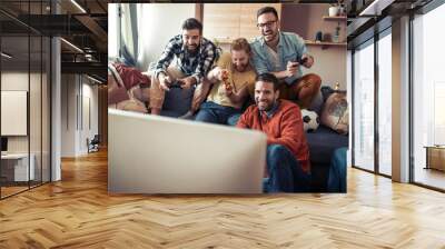 Friends enjoying playing video games at home Wall mural