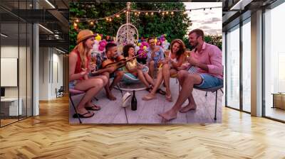 Group of friends having party by swimming pool. Wall mural