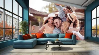 Group of friends taking a selfie with tablet Wall mural