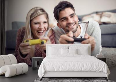 Happy couple play video game at home Wall mural