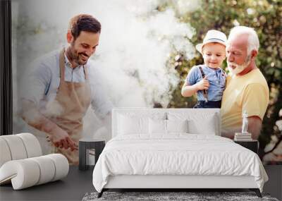 Happy  family barbecuing meat on the grill Wall mural