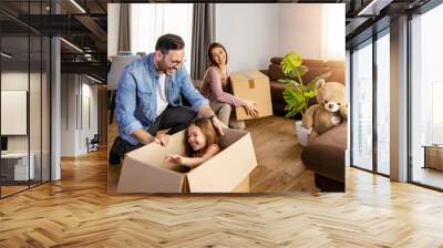 Happy family with child moving with boxes in a new apartment house Wall mural