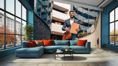 Portrait of handsome businessman outdoors Wall mural