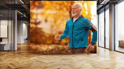 Senior man running in the park Wall mural