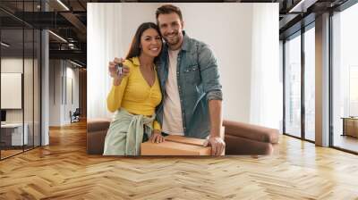 Smiling couple unpacking boxes in new home Wall mural