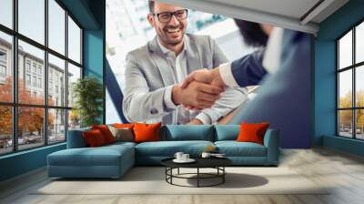 Two businessmen shaking their hands Wall mural