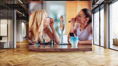 Two happy girls applying make up at home Wall mural