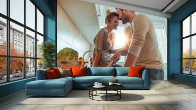 Young couple in kitchen preparing lunch Wall mural