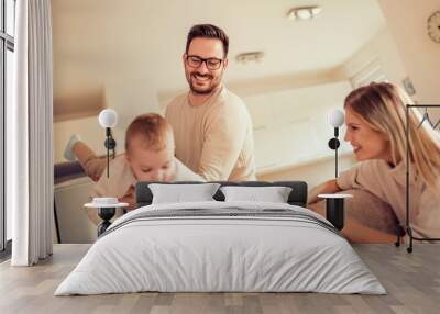 Young family playing at home Wall mural