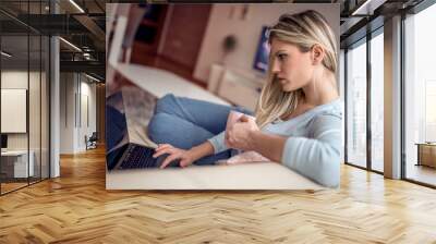 Young girl using laptop at home office Wall mural