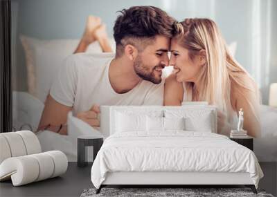 Young loving couple in the bed Wall mural