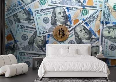 close-up of a golden shiny bitcoin cryptocurrency coin on us dollar bills. Wall mural