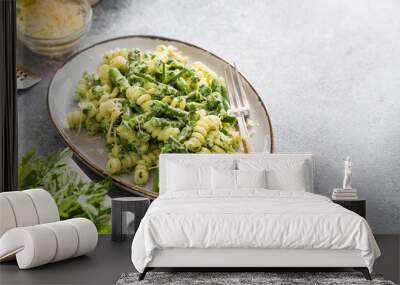 pasta with green vegetables and creamy sauce. fusilli pasta with asparagus beans and spinach on grey stone background Wall mural