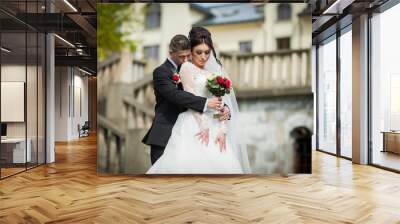 Sensual romantic groom hugging beautiful bride from behind, chur Wall mural