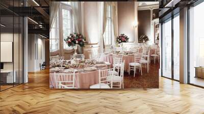 Wedding dinner table setting. Pink flowers and decor details on festive served tables Wall mural