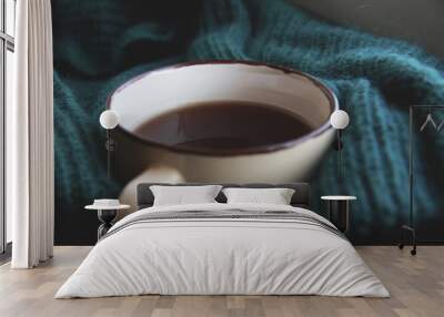 Cup of tea in knitted green sweater and morning lights from window Wall mural