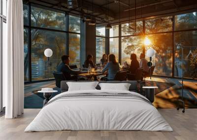 Diverse millennial business team talking in meeting room, negotiating on project at table at glass wall panoramic window during sunset, discussing deal in open space, modern office interior. Wide shot Wall mural