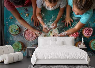 Parents and children baking cupcakes together, decorating them with colorful frosting and sprinkles. Children having fun making cupcakes, sharing food and water on table Wall mural