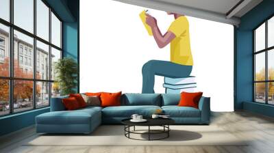 Dark-skinned teenage boy sits on a stack of books and reads a book that he holds in his hands Wall mural