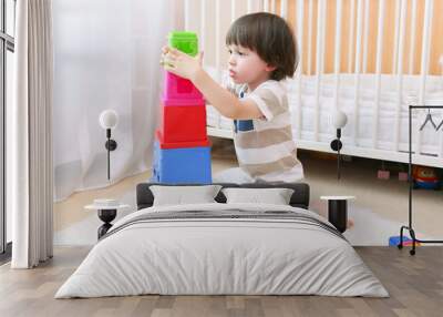 cute 2 years boy plays educational toy at home Wall mural